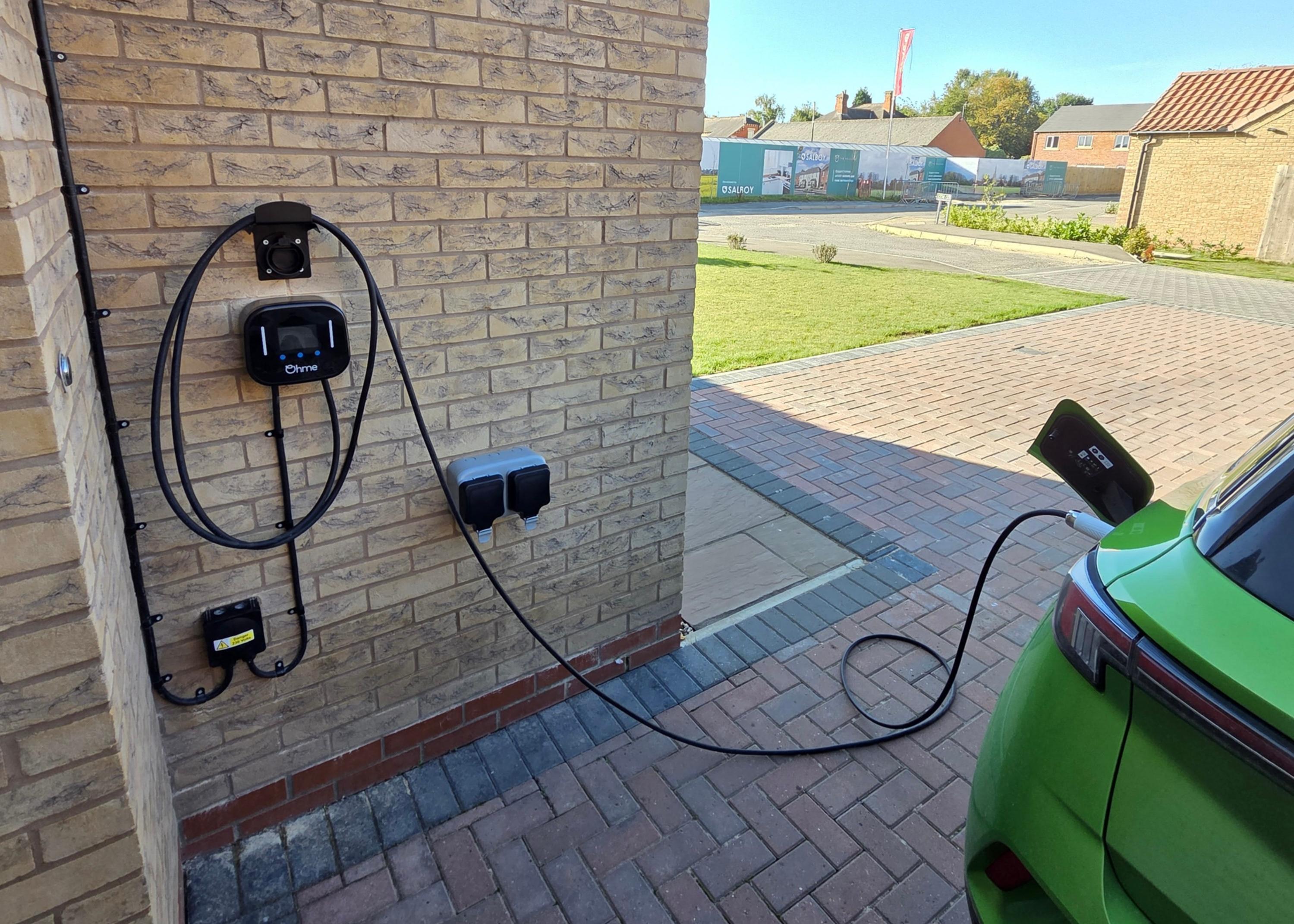 Home EV charging point installed on residential garage wall